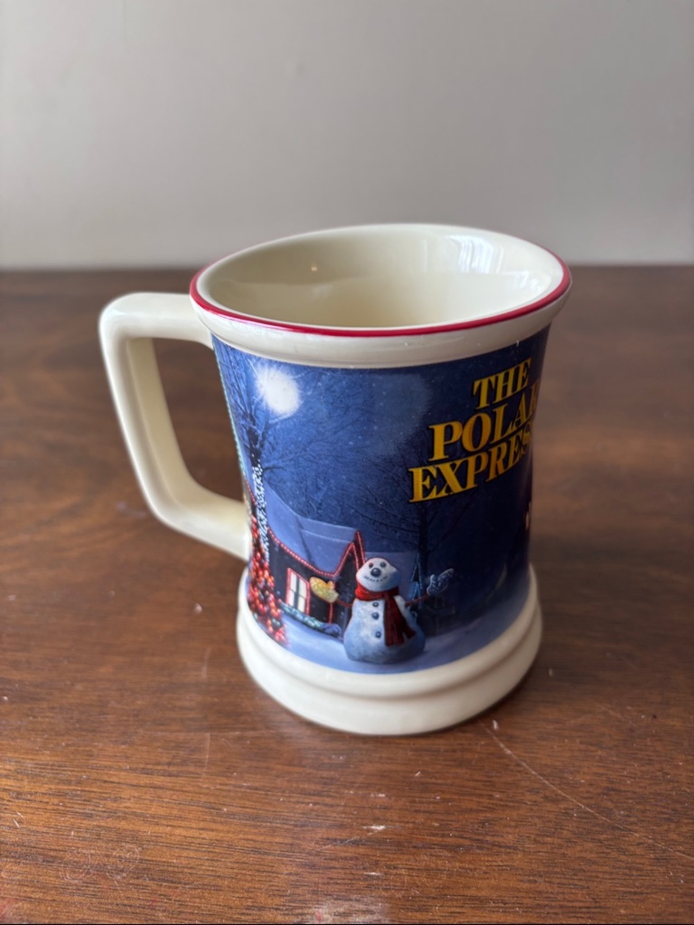 Warner Bros. The Polar Express Cream Mug with Blue Scenic Wrap and Red Rim
